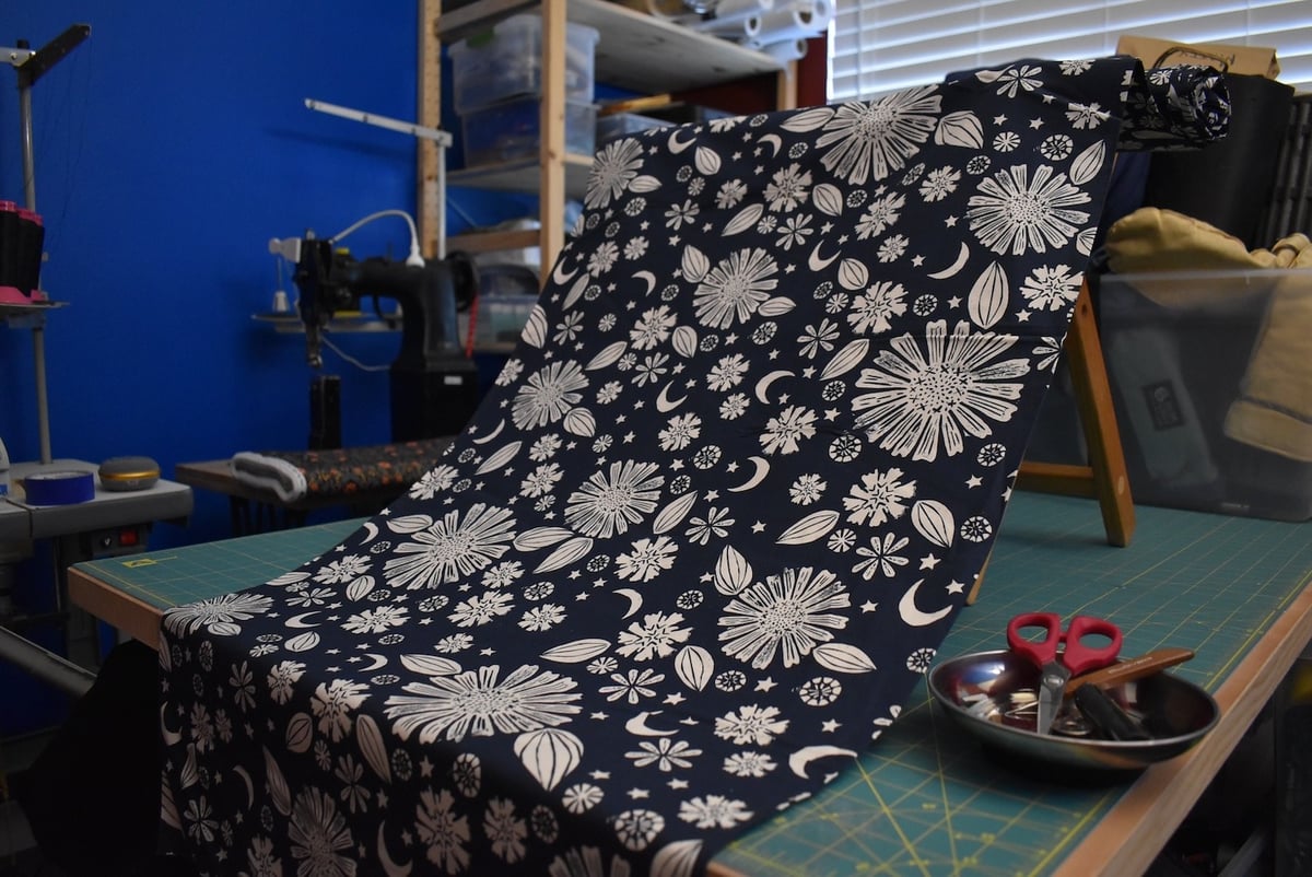 Navy fabric with a western-inspired floral motif draped over a stool